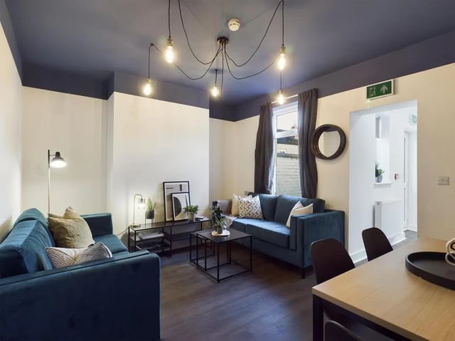 Two teal sofas coffee tables and lamps living room at 6 Bedroom House at 53, Ripon Street in Lincoln Student Accommodation