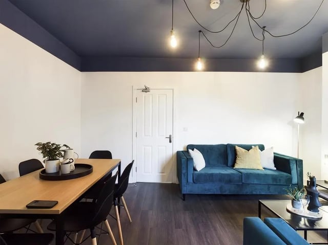 Dining table with chairs sofa and lamp living room at 6 Bedroom House at 53, Ripon Street in Lincoln Student Accommodation