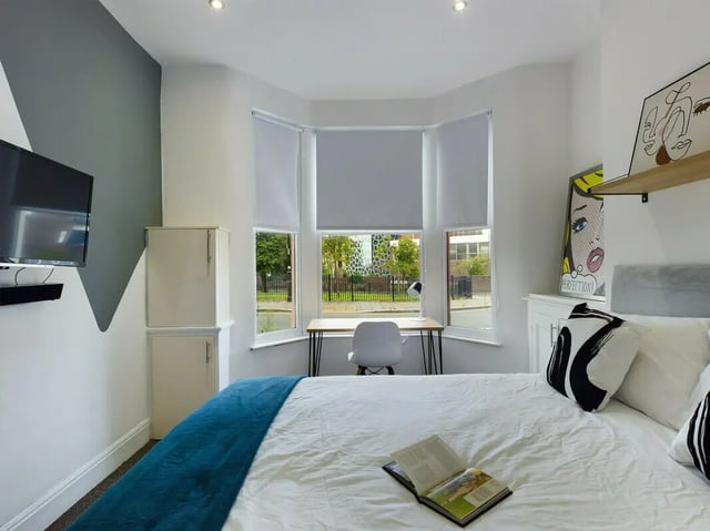 Bed study area white cabinets TV modern artwork bedroom at 4 Bedroom House at 107, Hall Lane in Liverpool Student Accommodation