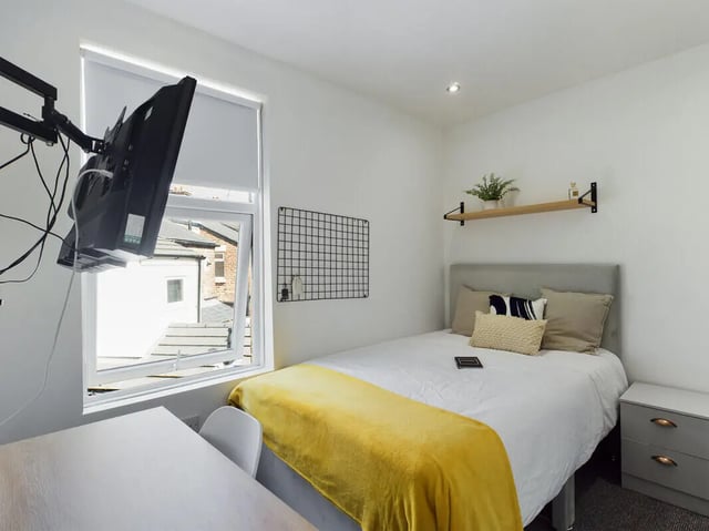 Bed desk mounted TV pillows yellow throw bedroom at 4 Bedroom House at 107, Hall Lane in Liverpool Student Accommodation