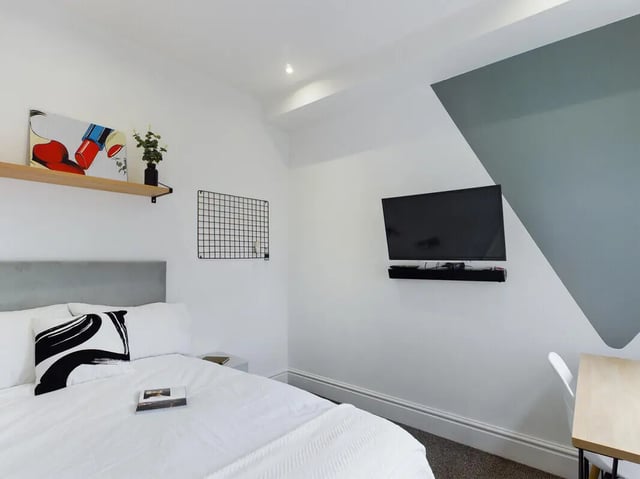 Bed with art plant grid and TV bedroom at 4 Bedroom House at 107, Hall Lane in Liverpool Student Accommodation
