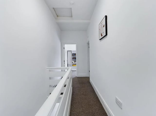 Hallway with white railing and artwork hallway at 4 Bedroom House at 107, Hall Lane in Liverpool Student Accommodation