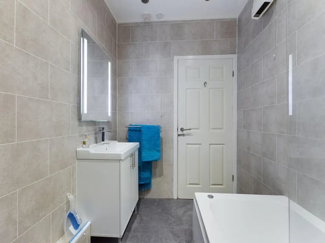 Vanity sink mirror and bathtub interior bathroom at 4 Bedroom House at 107, Hall Lane in Liverpool Student Accommodation