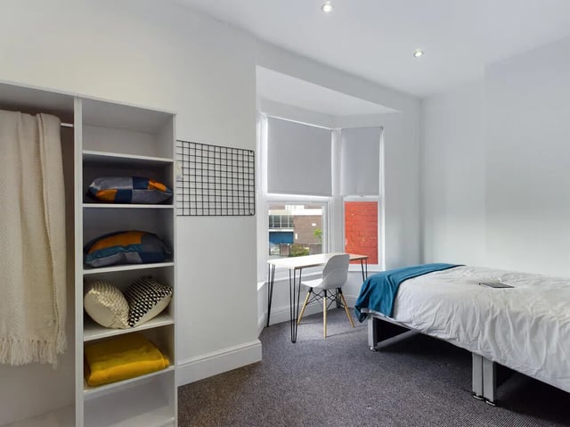 Bed desk shelf pillows blanket bedroom at 4 Bedroom House at 107, Hall Lane in Liverpool Student Accommodation