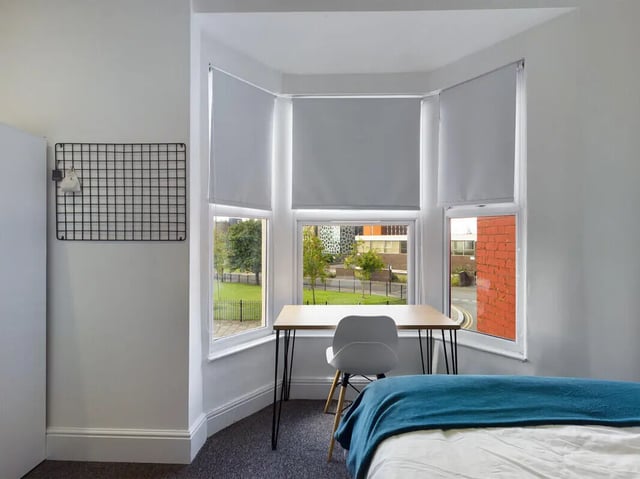 Desk chair grid and bed bedroom area at 4 Bedroom House at 107, Hall Lane in Liverpool Student Accommodation