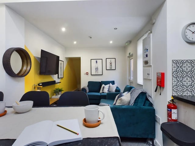Sofa TV mirror artwork kitchen fire extinguisher living room at 6 Bedroom House at 154, Empress Road in Liverpool Student Accommodation