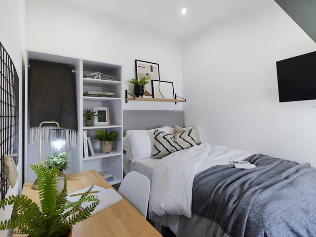 Bed desk shelf plants and television bedroom at 6 Bedroom House at 154, Empress Road in Liverpool Student Accommodation
