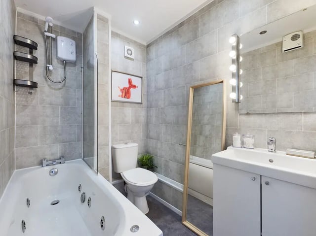 Bath with toilet sink mirror and art Bathroom at 6 Bedroom House at 154, Empress Road in Liverpool Student Accommodation