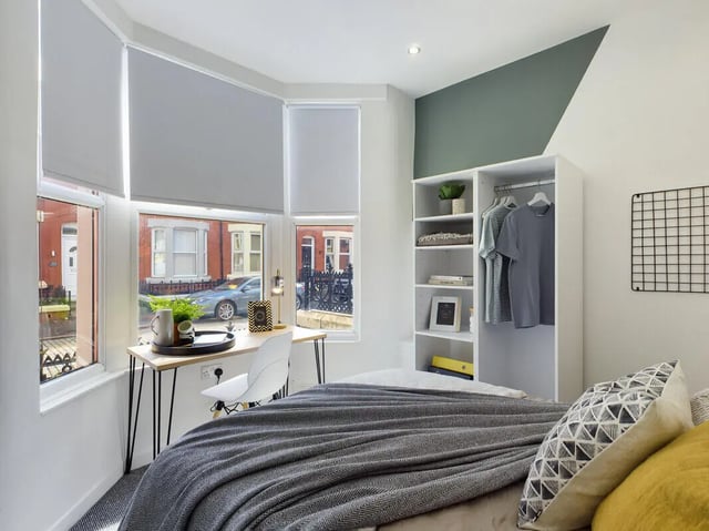 Bed desk chair closet with clothes bedroom at 6 Bedroom House at 154, Empress Road in Liverpool Student Accommodation