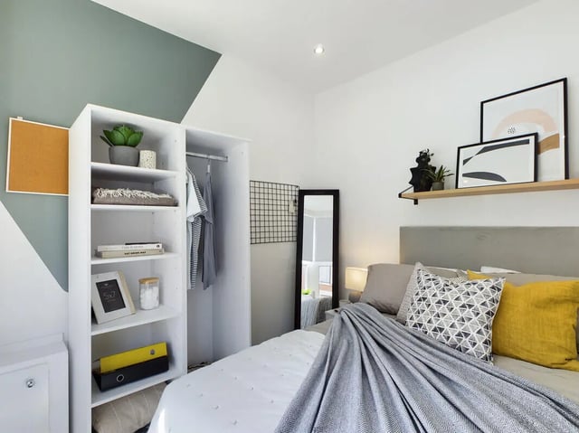 Closet bed pillows and artwork bedroom at 6 Bedroom House at 154, Empress Road in Liverpool Student Accommodation