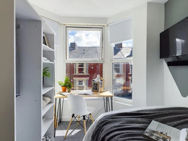 Desk plants chair open book wardrobe bedroom at 6 Bedroom House at 154, Empress Road in Liverpool Student Accommodation