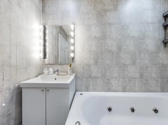 Sink vanity mirror lights bathtub bathroom at 6 Bedroom House at 154, Empress Road in Liverpool Student Accommodation