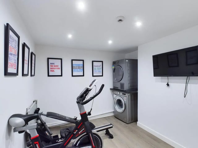 Exercise bike washing machine and dryer living room at 6 Bedroom House at 328, Upper Parliament Street in Liverpool Student Accommodation