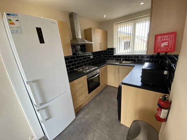 White fridge stove oven microwave fire blanket kitchen at 3 Bedroom House at 94, Minster Court in Liverpool Student Accommodation