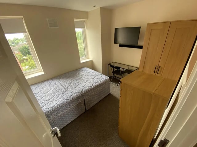 Bed desk wardrobe and television student bedroom at 3 Bedroom House at 94, Minster Court in Liverpool Student Accommodation