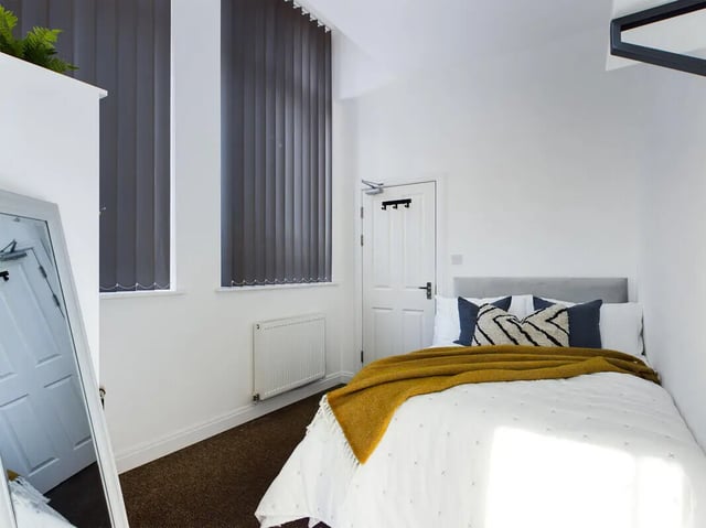 Bed with pillows blanket and mirror bedroom at 8 Bedroom House at 213, Smithdown Road in Liverpool Student Accommodation