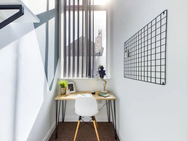 Desk chair lamp plants and grid board study area at 8 Bedroom House at 213, Smithdown Road in Liverpool Student Accommodation