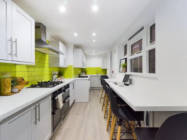 White cabinets green tiles oven breakfast bar kitchen at 8 Bedroom House at 213, Smithdown Road in Liverpool Student Accommodation
