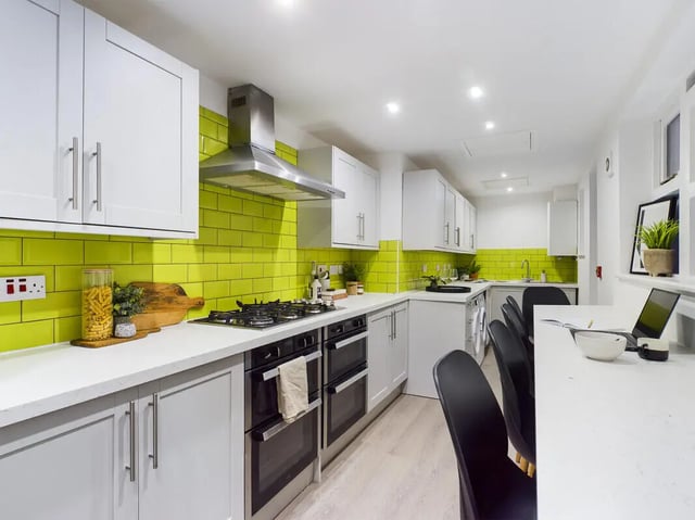 Modern white kitchen with yellow tile accents kitchen at 8 Bedroom House at 213, Smithdown Road in Liverpool Student Accommodation