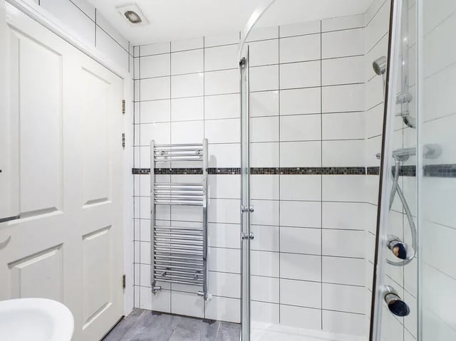 White tiled shower with towel rail bathroom at 8 Bedroom House at 213, Smithdown Road in Liverpool Student Accommodation