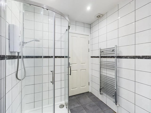 Glass shower enclosure towel rack white tiled walls bathroom at 8 Bedroom House at 213, Smithdown Road in Liverpool Student Accommodation