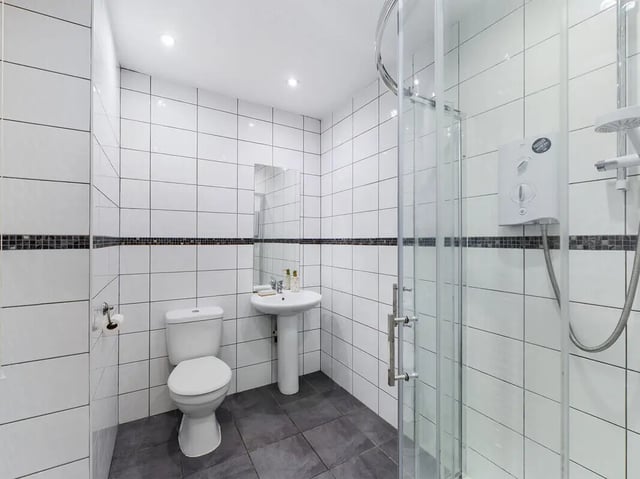 Toilet sink and shower in tiled bathroom. at 8 Bedroom House at 213, Smithdown Road in Liverpool Student Accommodation