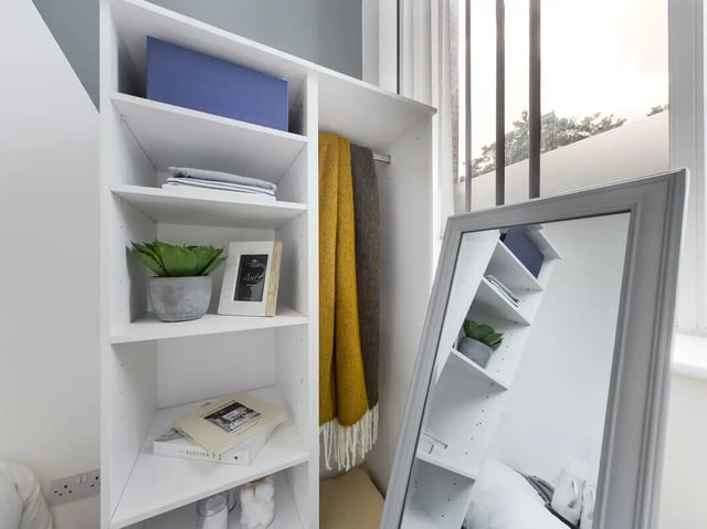 Shelving unit with blankets and mirror bedroom at 8 Bedroom House at 213, Smithdown Road in Liverpool Student Accommodation