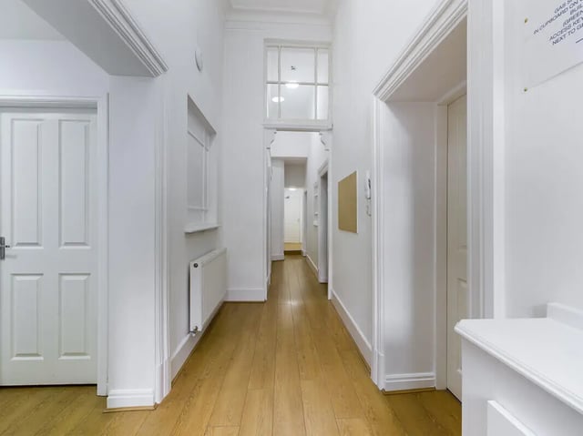 Hallway with doors radiator and wooden floor hallway at 8 Bedroom House at 213, Smithdown Road in Liverpool Student Accommodation