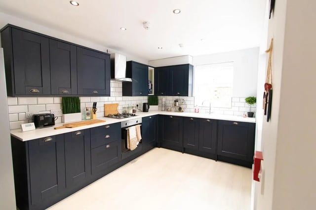 Dark blue cabinets white tiled backsplash stove kitchen at 6 Bedroom House at 85, Halsbury Road in Liverpool Student Accommodation