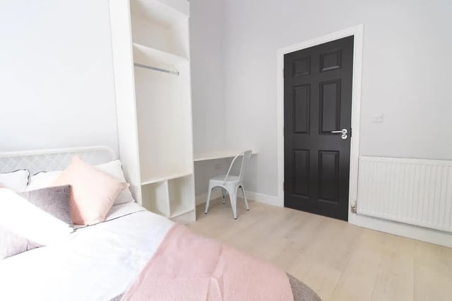 Bed wardrobe desk chair and black door bedroom at 6 Bedroom House at 85, Halsbury Road in Liverpool Student Accommodation