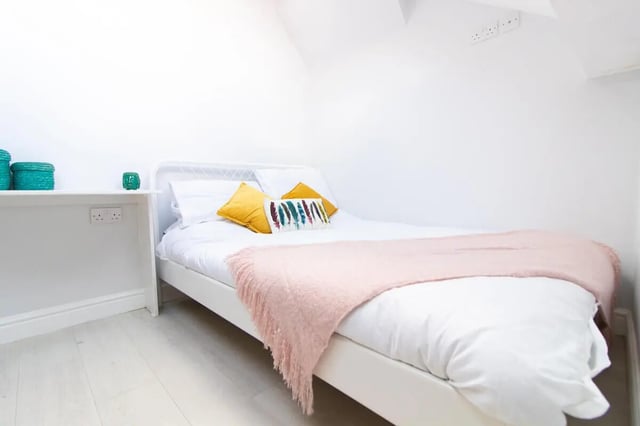Bed with yellow pillows pink throw bedroom at 6 Bedroom House at 85, Halsbury Road in Liverpool Student Accommodation