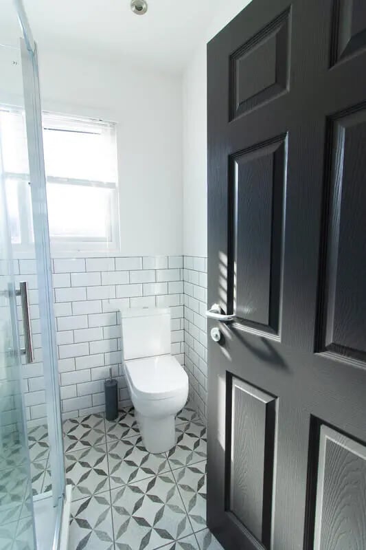 Toilet tiled shower black door bathroom at 6 Bedroom House at 85, Halsbury Road in Liverpool Student Accommodation