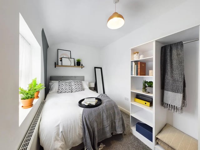 Bed with tray plants and shelves bedroom at 9 Bedroom House at 76, Burleigh Street in Manchester Student Accommodation
