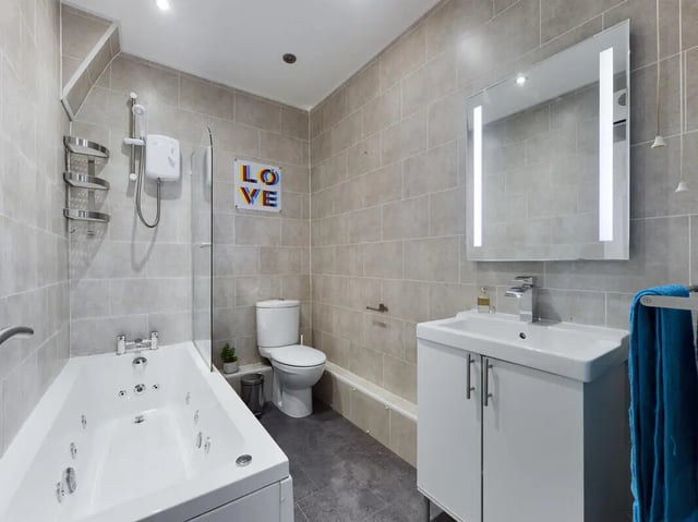 Bathtub toilet vanity with mirror bathroom at 9 Bedroom House at 76, Burleigh Street in Manchester Student Accommodation