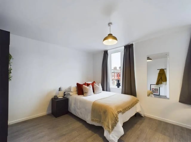 Bed with pillows blanket and nightstand bedroom at 7 Bedroom House at 5, CYRIL STREET in Manchester Student Accommodation