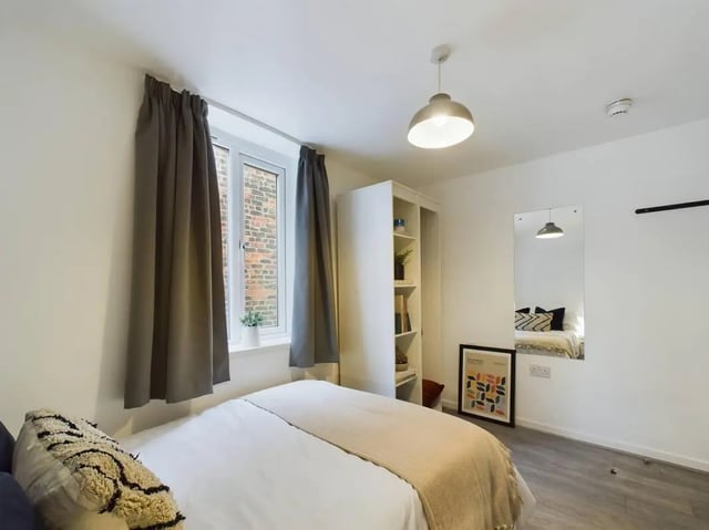 Bed shelves mirror and artwork bedroom at 7 Bedroom House at 5, CYRIL STREET in Manchester Student Accommodation