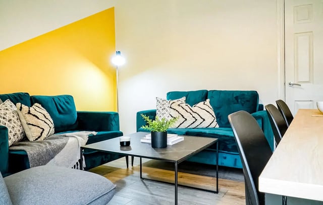 Two sofas coffee table pillows lamp living room at 5 Bedroom House at 14, Driffield Street in Manchester Student Accommodation