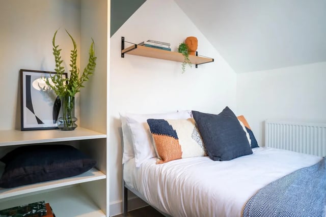 Bed with patterned pillows and artwork Bedroom at 3 Bedroom House at Flat 1, 7, EILEEN GROVE in Manchester Student Accommodation