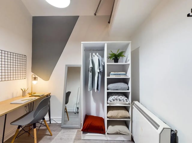 Desk chair wardrobe mirror and plant study area at 7 Bedroom House at 39, Ossory Street in Manchester Student Accommodation