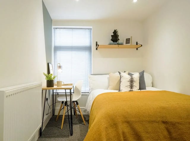 Bed desk chair radiator pillows blankets study area bedroom at 6 Bedroom House at 28, Ruskin Avenue in Manchester Student Accommodation