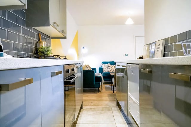 Modern kitchen with teal sofa living area kitchen at 6 Bedroom House at 28, Ruskin Avenue in Manchester Student Accommodation