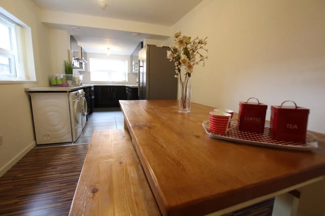 Wooden table with cups and tea coffee tins kitchen at 6 Bedroom House at 49, Ruskin Avenue in Manchester Student Accommodation