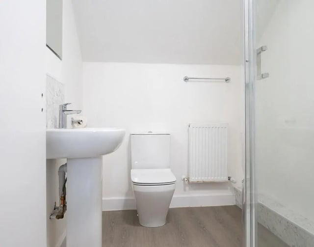 Sink toilet radiator and shower enclosure bathroom at 3 Bedroom House at 68, St. Bees Close in Manchester Student Accommodation