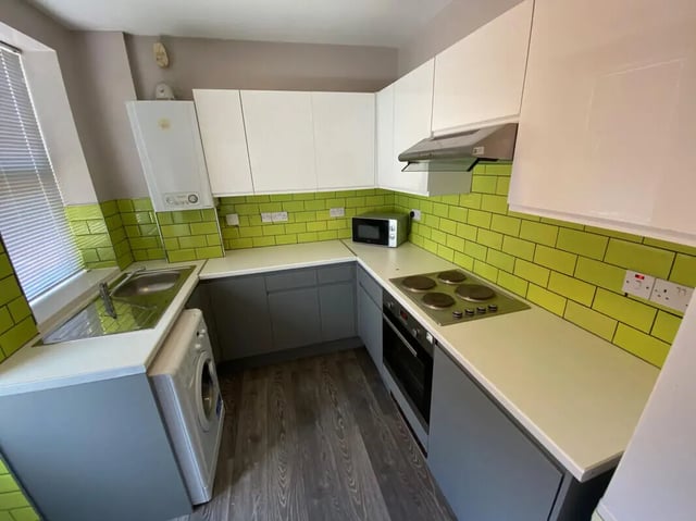 Sink washing machine microwave stove kitchen at 4 Bedroom House at 16, Lovat Road in Preston Student Accommodation