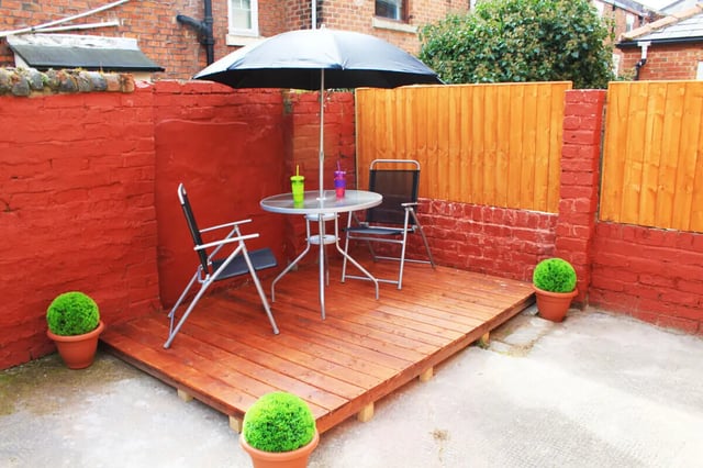 Deck with table chairs umbrella plants exterior at 4 Bedroom House at 16, Lovat Road in Preston Student Accommodation
