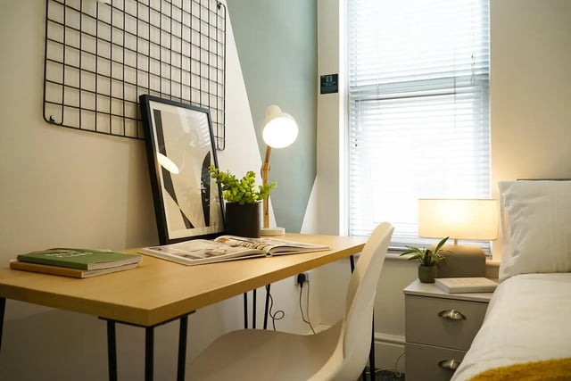 Desk chair framed art books plant lamp bedside table bedroom at 7 Bedroom House at 146, West Parade in Lincoln Student Accommodation