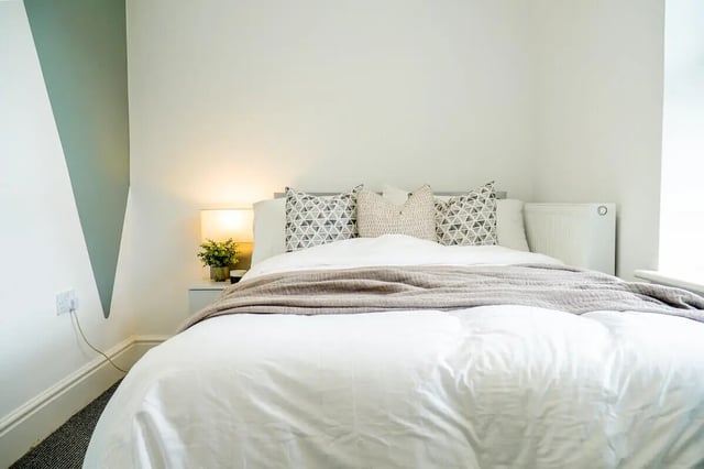 Bed with patterned pillows radiator lamp bedroom at 7 Bedroom House at 146, West Parade in Lincoln Student Accommodation