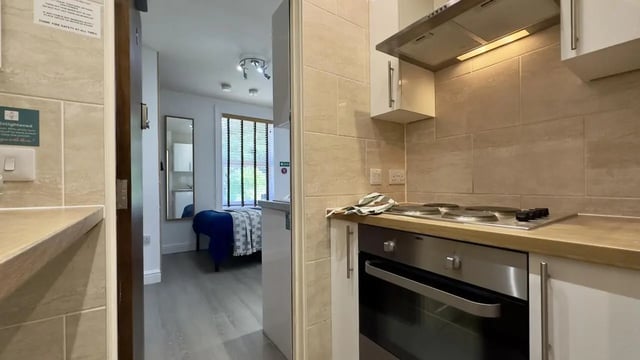 Kitchen with oven stove and bedroom beyond at 6 Bedroom House at 12, Studios at, Richmond Road in Lincoln Student Accommodation