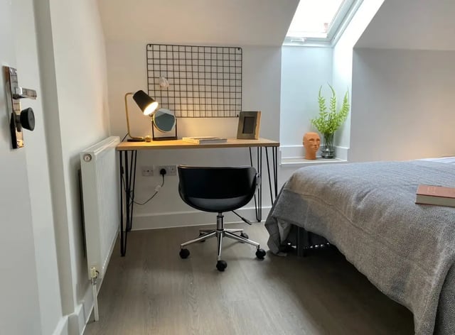 Desk chair lamp mirror grid and bed bedroom at 6 Bedroom House at 232, West Parade in Lincoln Student Accommodation