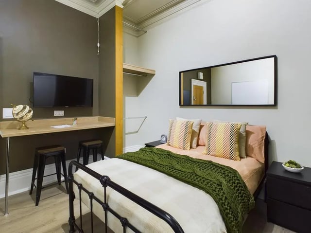 Bed desk stools TV globe and mirror bedroom at 7 Bedroom House at 19, Studios at, The Avenue in Lincoln Student Accommodation
